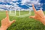 Female Hands Framing House Over Grass Field and Sky