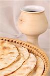 Chalice with red wine and pita bread