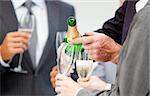 Close-up of a businessman serving Champagne in the office
