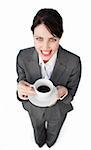 Sparkling businesswoman drinking a cup of coffee isolated on a white background