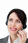 Self-assured businesswoman with headset on against a white background