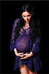 beautiful sensual pregnant woman holding her stomach