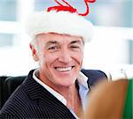 Mature businessman celebrating christmas in the company