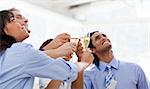 Cheerful multi-ethnic business team toasting with Champagne in a meeting