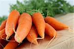 Bunch of fresh organic carrots on cutting board