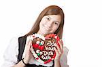 Bavarian woman in love holds Oktoberfest heart. Isolated on white background.