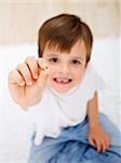 Little boy showing his first milk-tooth that has fallen out