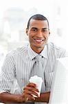Afro-american businessman drinking a coffee in the office