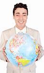 Assertive male executive holding a terrestrial globe isolated on a white background