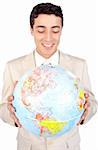 Positive male executive looking at a globe isolated on a white background