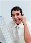Assertive businessman talking on headset at work