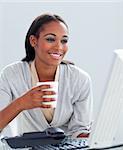 Confident businesswoman drinking a coffee at her desk in the office