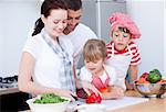 Portrait of a family preparing a meal in a kitchen