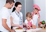 Portrait of a adorable family preparing a meal in a kitchen