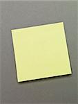 Yellow Adhesive Note on grey background