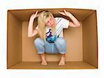 Young woman inside a Cardboard Box isolated on white