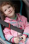 Cute little girl in a baby car seat.