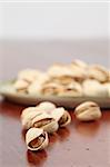 Close-up of pistachio nuts on a wooden table. Shallow dof