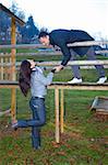 Young couple playing around in the nature - front view.