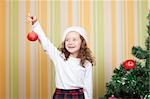 beautiful little girl sharing a christmas toy