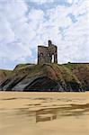 the old ruin of a castle in ballybunion overlooking the beach