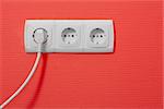 Electric outlets on red wall