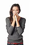 A woman with a cold or allergy wiping or blowing her nose.