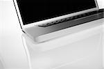 crop of modern aluminium laptop on white background with reflection