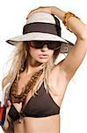 blond girl with summer hat and sunglasses taking a glass ith a red drink