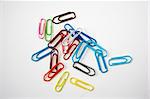 Many colored paper clips isolated on white