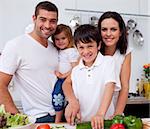Affectionate young family cooking together in the kitchen