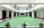 Open atrium with  facing corridors and man made lawn floor in an office building