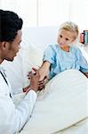 Male doctor giving a child patient an injection in a hospital