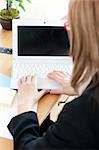 Close-up of a businesswoman working at a laptop in the office