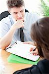 Charismatic  businessman showing a contract to a customer in the office