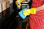 Close-up of a young woman doing housework in the kitchen