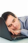 Tired businessman sleeping in the office, he putting his head onto keyboard of the laptop