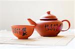 Chinese ceramic teapot and cups. The Chinese word on the pot is a poem.