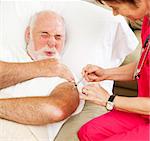 Senior man gets a painful injection from a home health nurse.