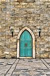 City scenery with old door on wall in street.