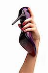 Female hand holding violet varnish shoes on a high heel