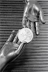 silver euro coins in futuristic robot gray metallic hands bank metaphor