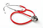 Medical still photo with red stethoscope over white background