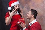 in love young couple with christmas clothes and surprising gift
