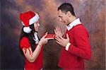 in love young couple with christmas clothes and red box gift