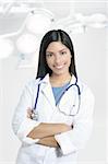 Beautiful brunette indian young happy doctor woman on surgery hospital