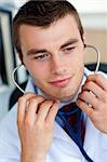 Portrait of an assertive male doctor holding a stethoscope