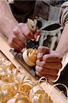 Man hands with carpenter's plane on wooden background