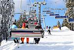 Skiers go on the lift on mountain in Bukovel, Ukraine