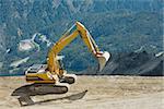 Excavator machine at a high mountain construction site